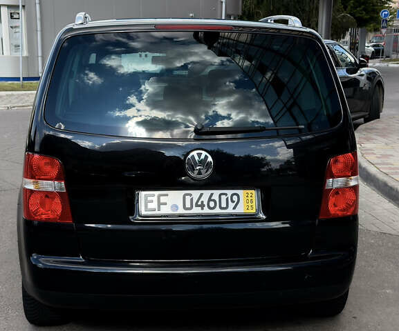 Черный Фольксваген Туран, объемом двигателя 1.6 л и пробегом 190 тыс. км за 6999 $, фото 1 на Automoto.ua